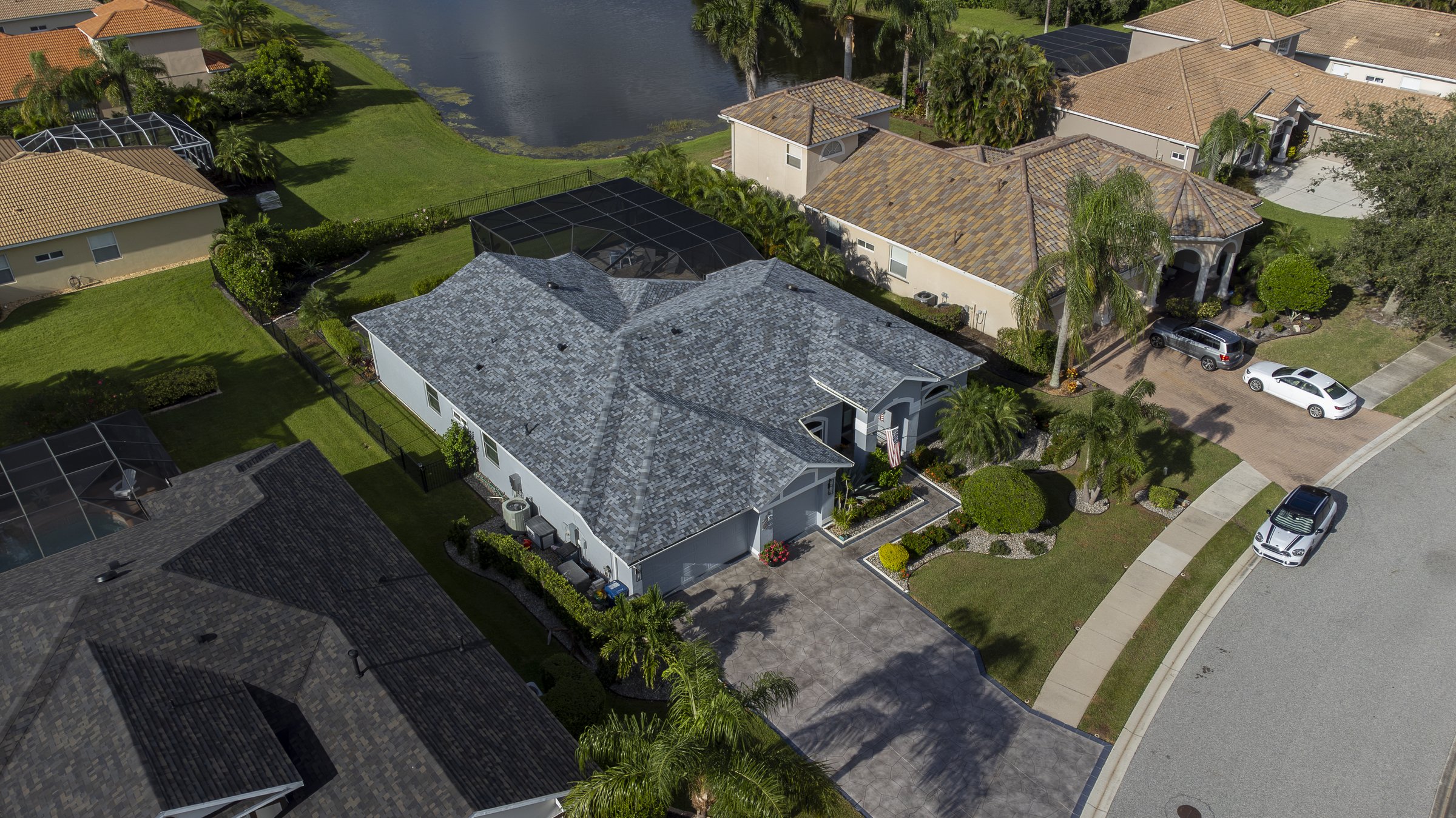 Angled drone aerial of lakefront luxury home