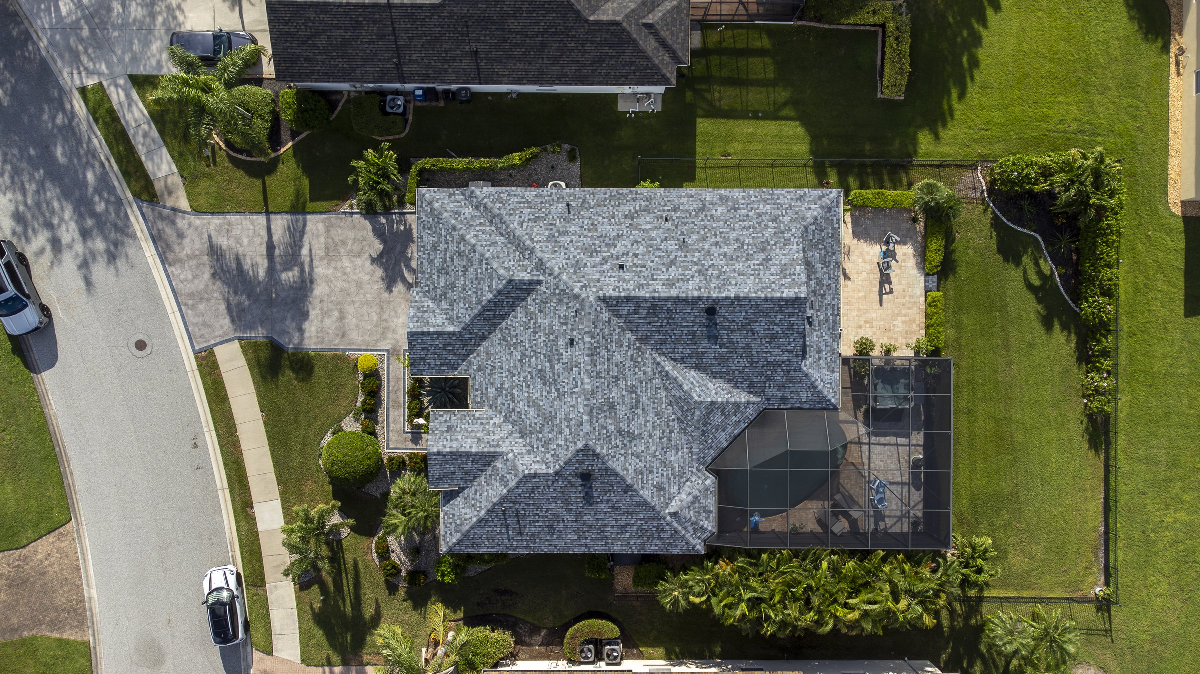 Top-down drone aerial of a single-family Sarasota home with grey roof — FAA Part 107 drone photography by LF Property Media