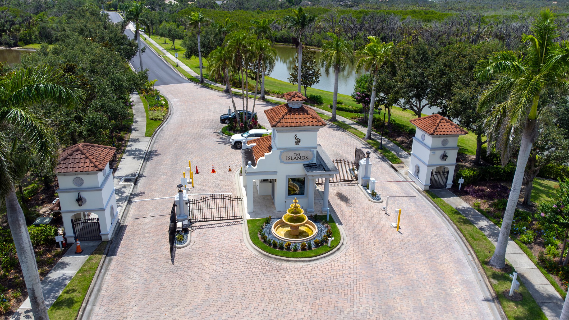 Grand gated community entry with fountain — Sarasota Florida drone aerial