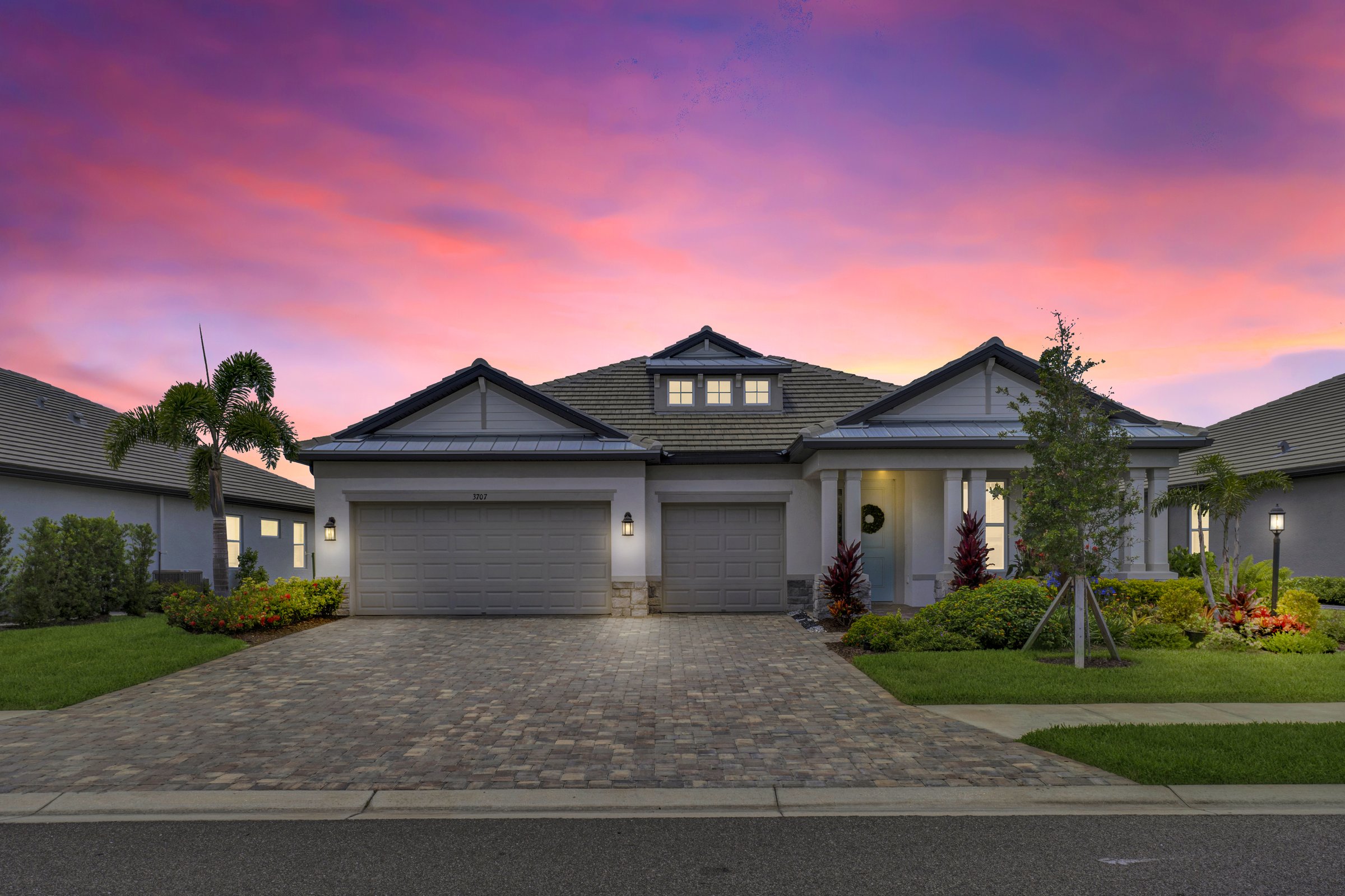 Twilight luxury home with painted Florida sky