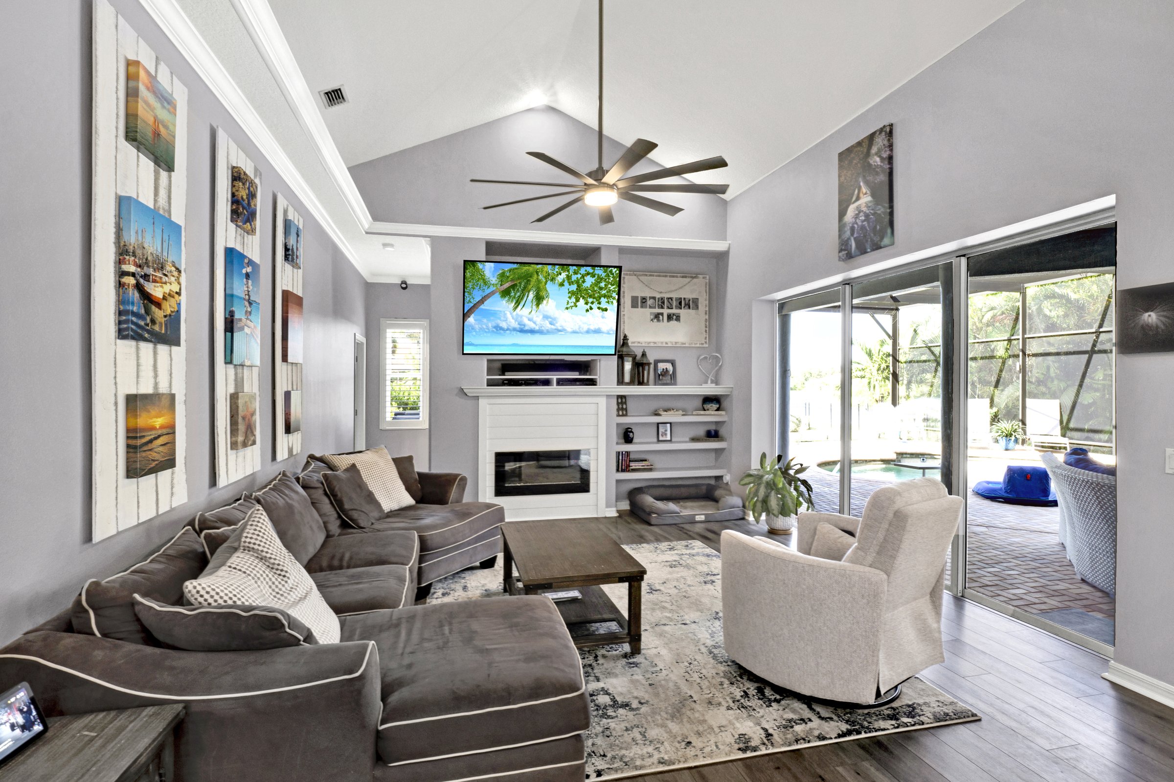 Vaulted-ceiling living room with sliding glass doors to lanai in a Sarasota home
