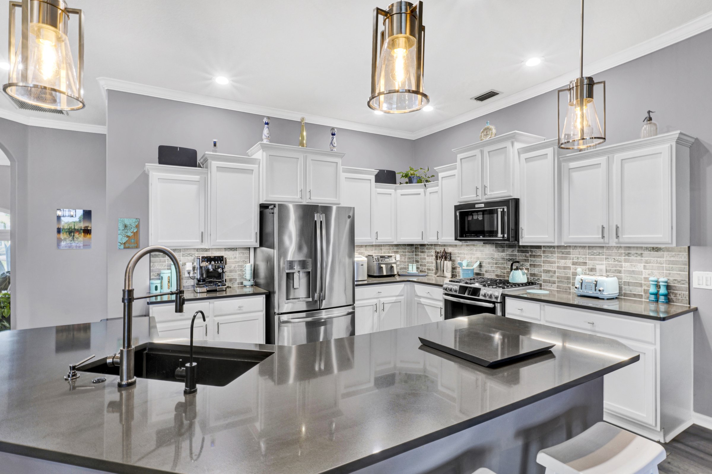 Bright kitchen with pendant lighting in a Sarasota home — real estate photography by LF Property Media